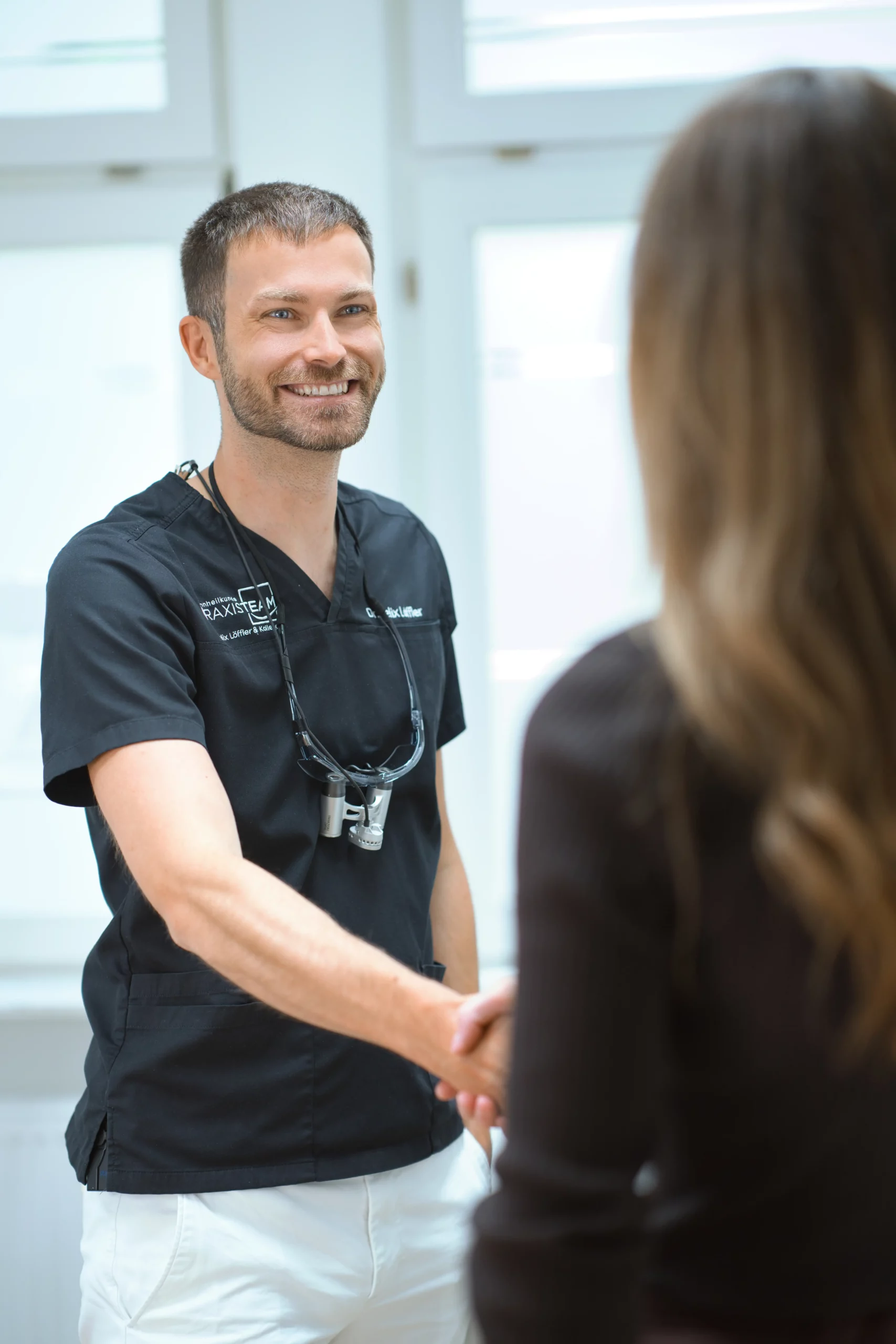 Persönliche Begrüßung einer Patientin in der Zahnarztpraxis